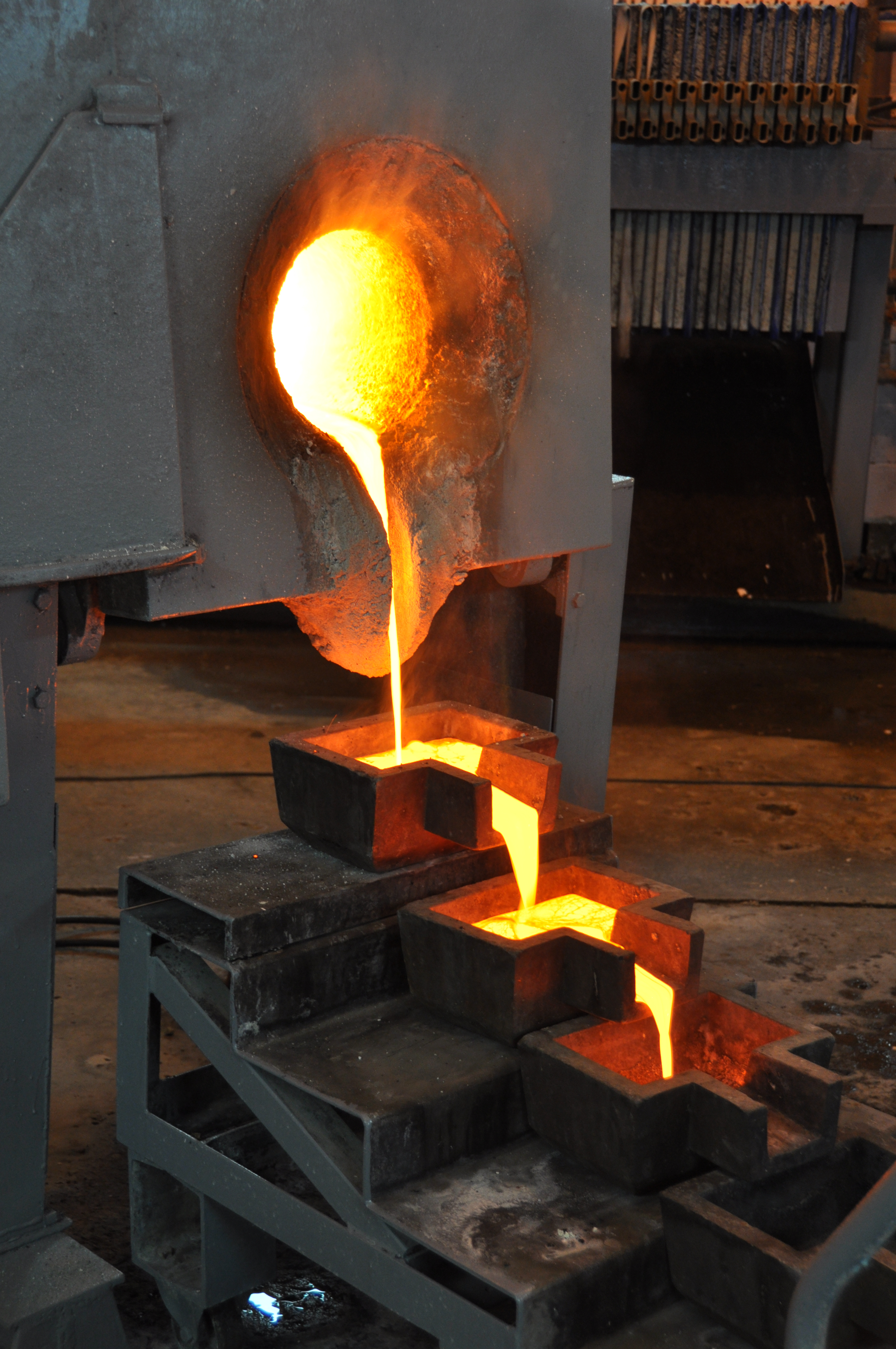 Molten gold-silver doré poured from a furnace into ingot moulds at a producer mill